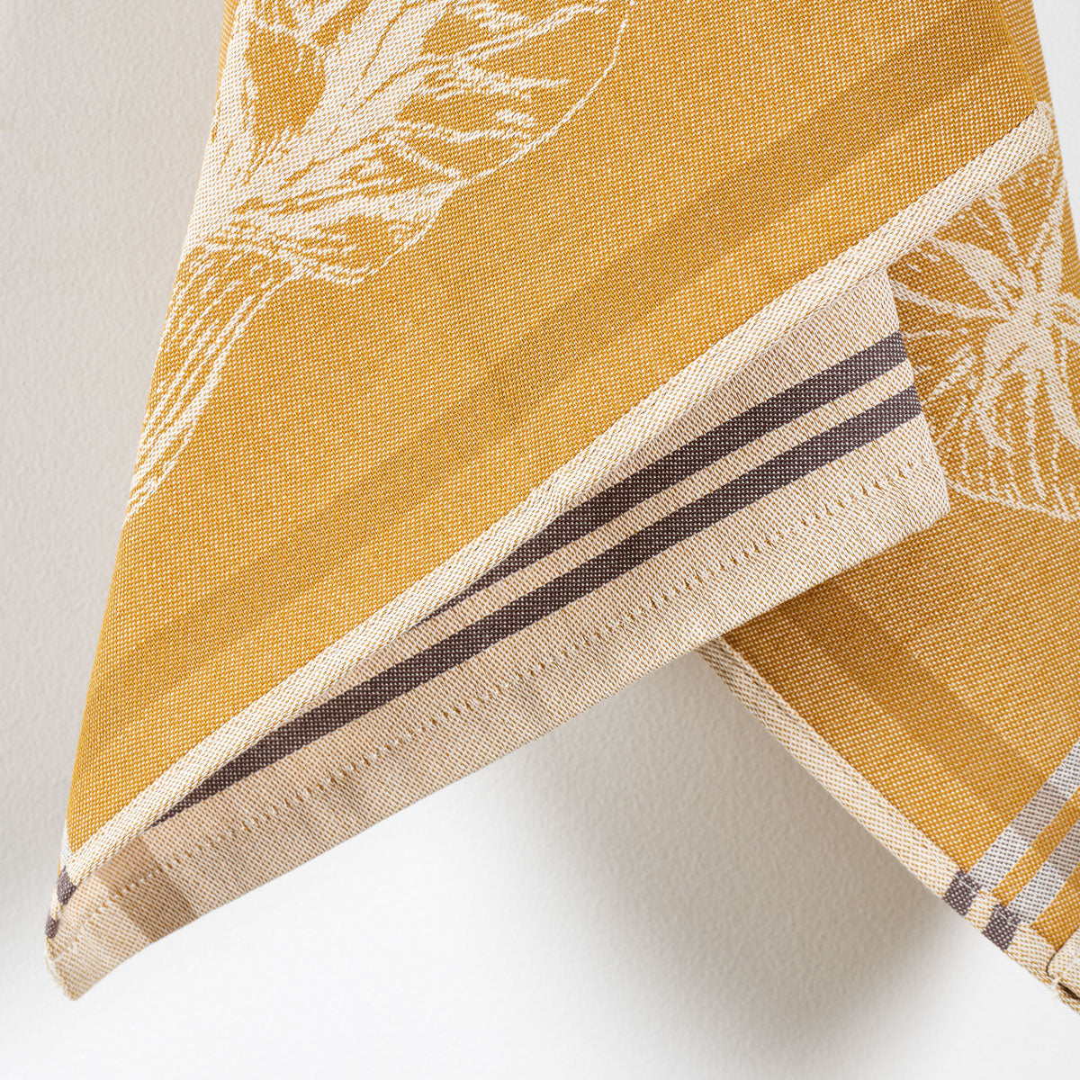Détail tissage jacquard
Zoom sur le tissage et les motifs de légumes. ocre