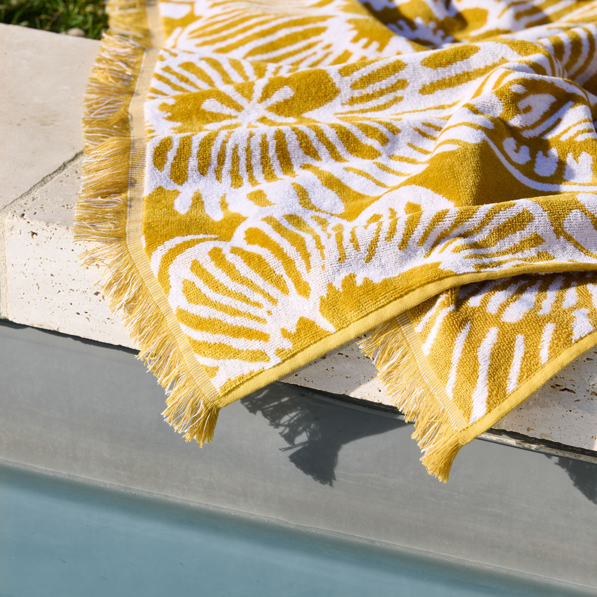 Zoom sur le jacquard relief, les liteaux travaillés et les franges épaisses
